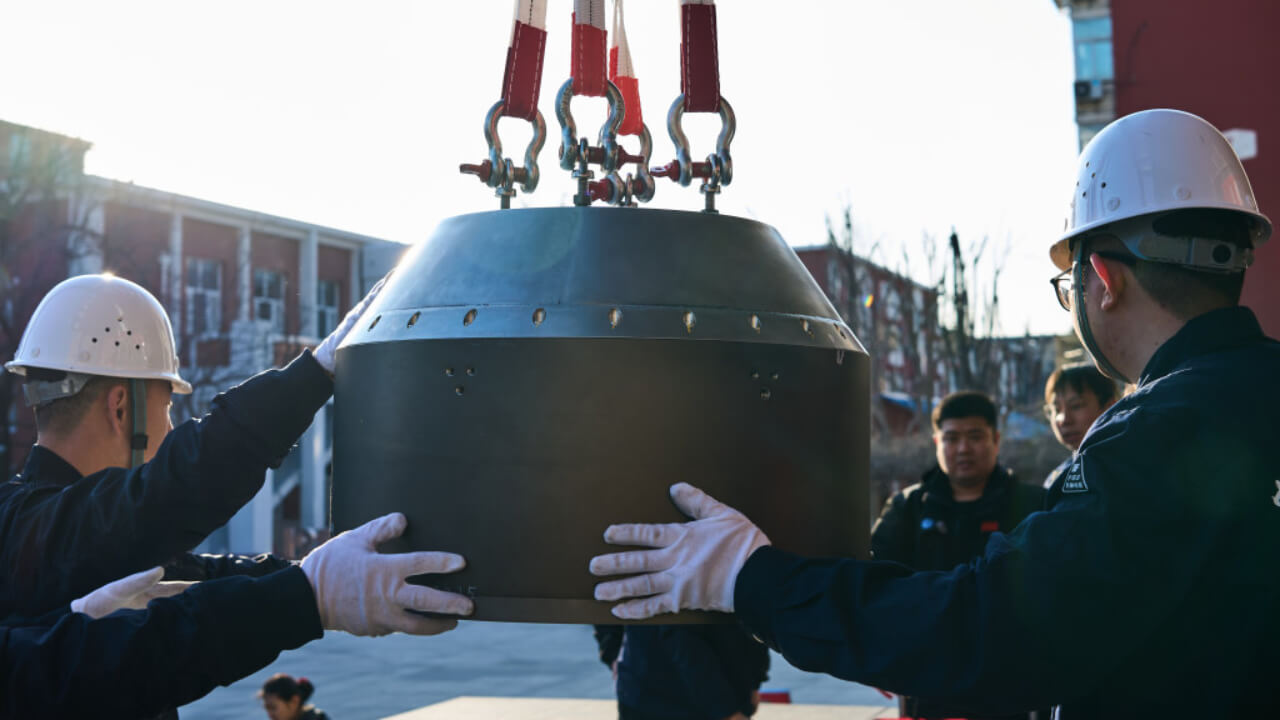 Recovery crew retrieves the payload capsule after landing.