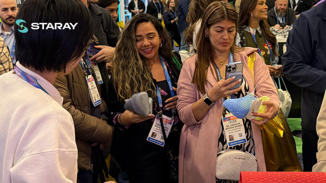 Visitors inspect the integrated lattice structure of STARAY's 3D printed shoes at CES 2026