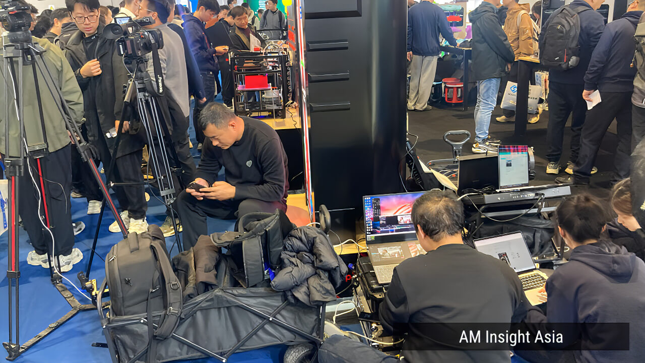 A professional media crew with full equipment on the show floor — no expense spared when it comes to content creation.