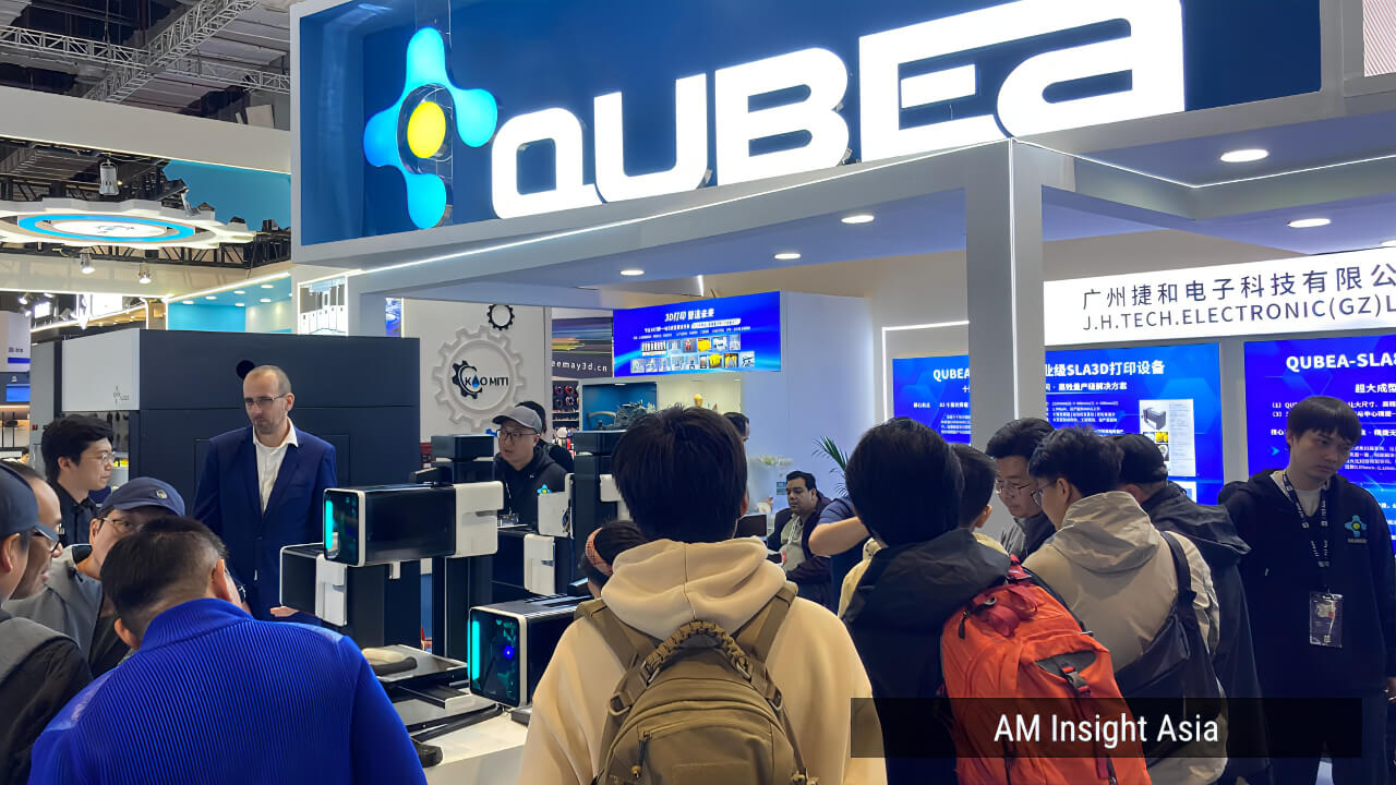 QUBEA booth at TCT Asia 2026, with the new FDM-style photopolymer prototype attracting international visitors. | Photo: AM Insight Asia