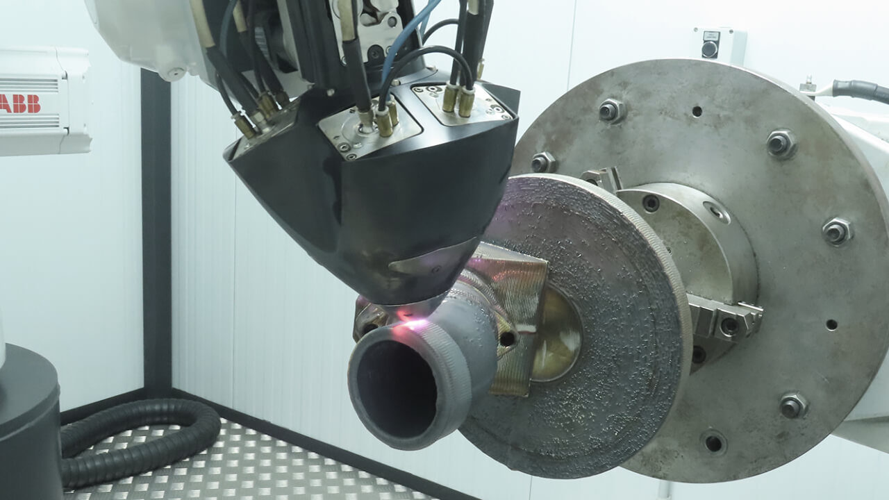 The SS316L flange component being printed with a Meltio head mounted on an ABB robotic arm