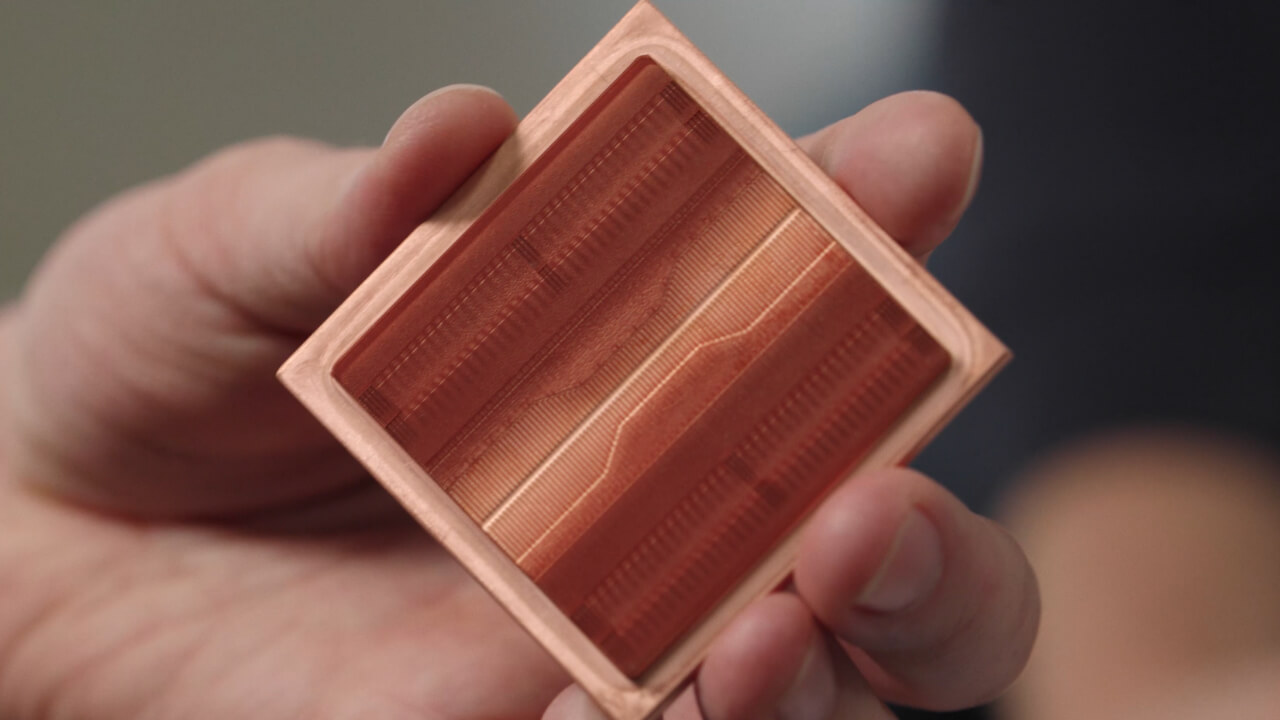 Close-up of an ECAM-printed copper cold plate, showing the high-precision parallel micro-channels formed inside. | Video still: Fabric8Labs