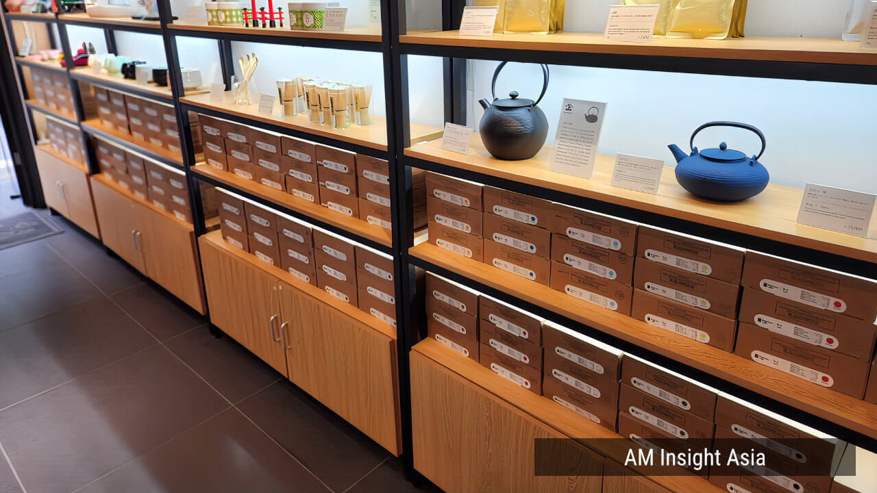 Shelves lined with tea ware and tea canisters, with filament boxes stacked below | Photo: AM Insight Asia